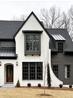 a white and gray house with black shutters