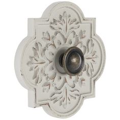 a white door knob with an ornate design on it