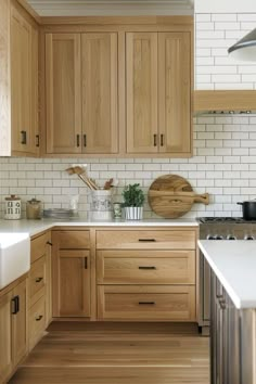 a kitchen with wooden cabinets and white counter tops