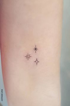 three stars tattoo on the left side of the leg, with one small star in the middle