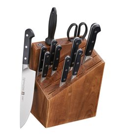 a knife block with six knives in it and one on the other side that has black handles