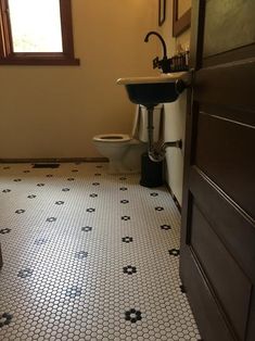 the bathroom is clean and ready for us to use it's new tile floor