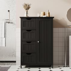 a bathroom with a black cabinet next to a shower