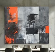 an abstract painting hangs on the wall above a dining room table