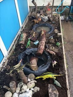 there are many toys in the garden and one is laying on top of the dirt