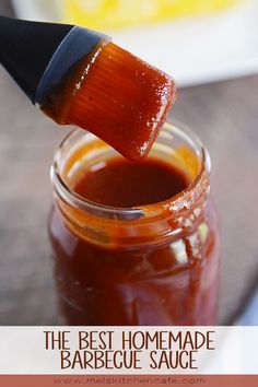 a jar filled with ketchup sitting on top of a wooden table