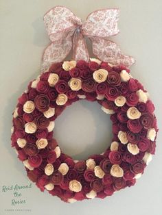 a red and white wreath hanging on the wall