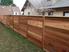 a wooden fence in front of a house