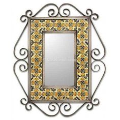 a decorative mirror with an ornate frame and yellow flowers on the border, is shown