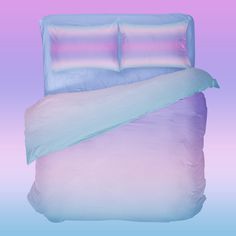 a bed with two pillows on top of it and a blue comforter in the middle