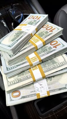 stacks of money sitting in the center console of a car