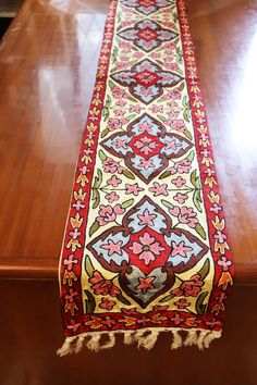 a long table runner on top of a wooden table