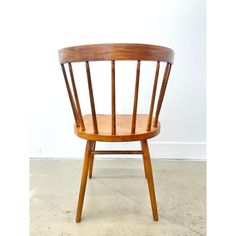 a wooden chair sitting on top of a cement floor