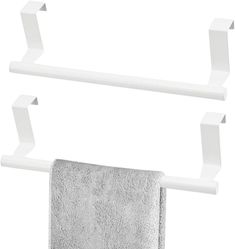 two white towel racks with one hanging on the wall