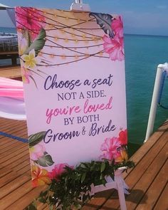 a sign that says choose a seat not a side you're loved by both groom and bride