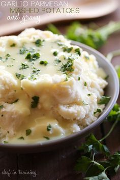 mashed potatoes with garlic and parsley in a bowl on a wooden table, ready to be eaten