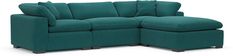 a blue sectional sofa with pillows on the back and footrests that are facing each other