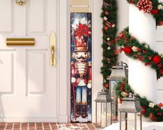 a christmas door cover with a nutcracker and wreath on it next to two lanterns