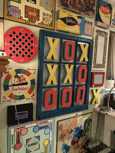 a wall covered in lots of different types of game boards and magnets on it