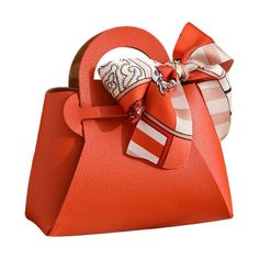 an orange purse with a bow on it