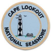 the badge for cape lookout national seashore is shown in black and white on a light blue background