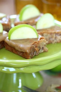 a green plate topped with slices of cake covered in caramel and apple toppings