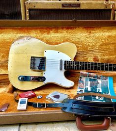 an old guitar and other items are on display