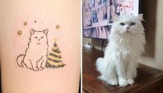 a white cat sitting on top of a wooden table next to a christmas tree tattoo