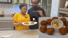 a man and woman standing in front of a plate of food