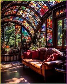 a living room with stained glass windows and leather couches in it's center