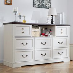 a white dresser with lots of drawers on top of it