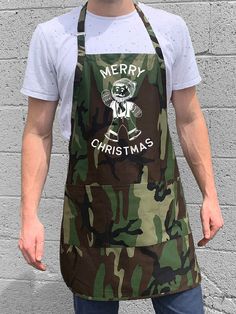 a man wearing an apron that says hey all you cool cats and kittens