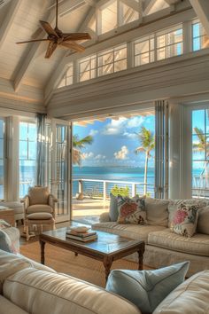 a living room filled with furniture next to the ocean