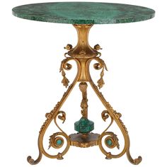 an ornate table with green marble top