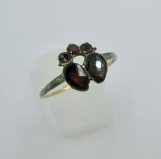 For Sale on 1stdibs - A very early Georgian ring with flat cut Almandine Garnets set in a crowned double heart ring dating to the 1700s. A museum quality jewel from the collection Georgian Engagement Ring, Esoteric Jewelry, Rose Cut Diamond Pendant, Gold Museum, Georgian Ring, Double Heart Ring, Contemporary Engagement Rings, Almandine Garnet, Heart Shaped Diamond