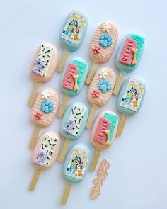 there are many decorated lollipops on the stick with different colors and designs