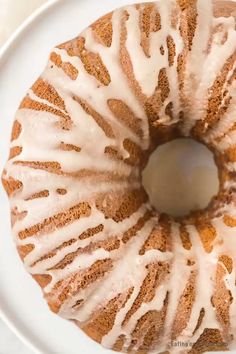 a bundt cake with icing on a white plate