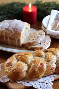 two plates with pastries on them next to a candle