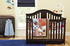 a baby crib in a room with blue rugs and wall decals on the walls