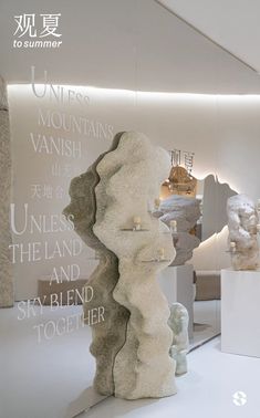 there are many sculptures on display in the room