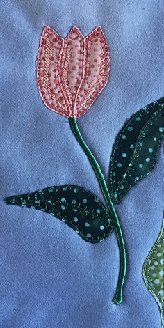 a close up of a flower on a blue cloth