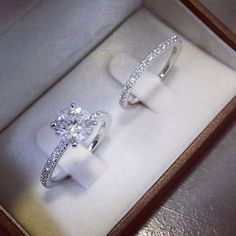 two engagement rings in a box on display