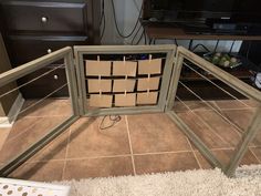 a cardboard box is sitting on the floor in front of a television set that has been taped to it