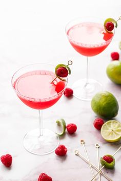 two glasses filled with raspberry margarita cocktails