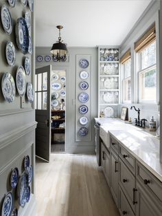 a kitchen filled with lots of blue and white plates