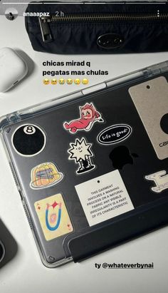 a laptop with stickers on it sitting next to a mouse