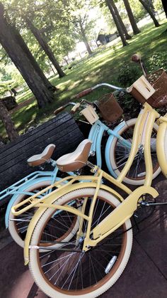 three bikes are parked next to each other in the park with trees and grass behind them