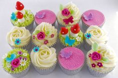 there are many cupcakes with flowers on them