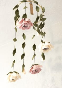 a mobile with flowers hanging from it's sides