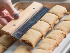 a person is cutting up some food on a tray